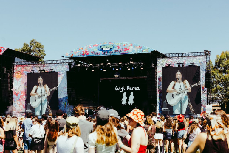 Singer Lucy Dacus performing live on the main stage with large screen projections at St Jerome's Laneway Festival before a large outdoor crowd.